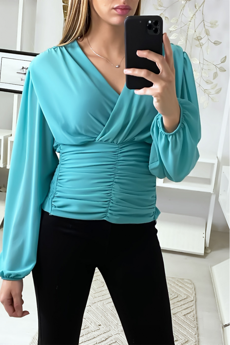 Blouse turquoise croisé au buste et cintré à la taille Blouse turquoise croisé au buste et cintré à la taille