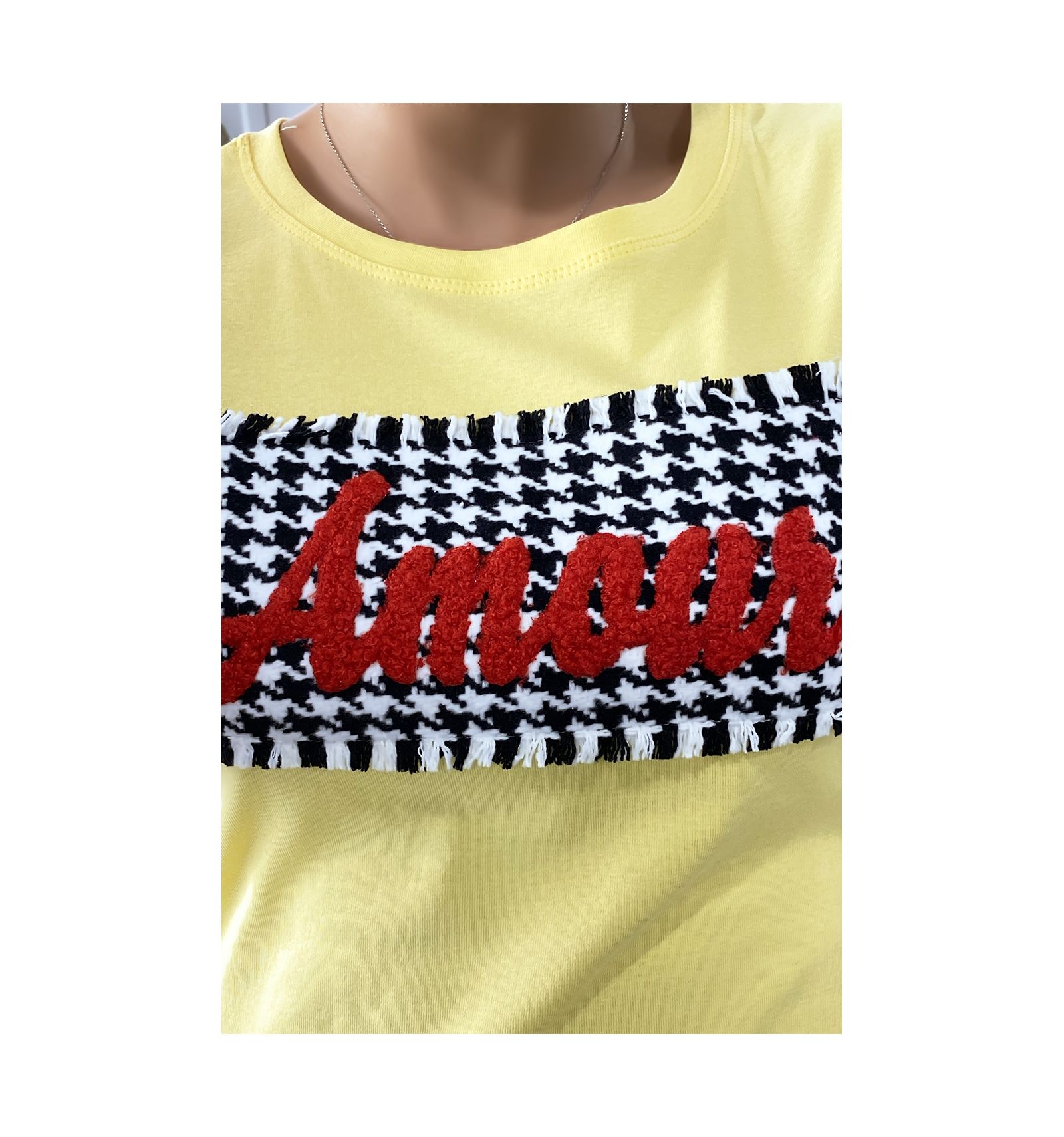 yellow shirt with red writing